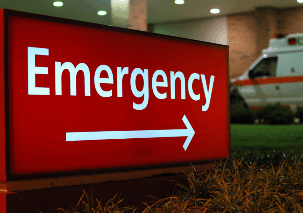 Red illuminated ER sign with arrow, guiding patients during an emergency in Texas