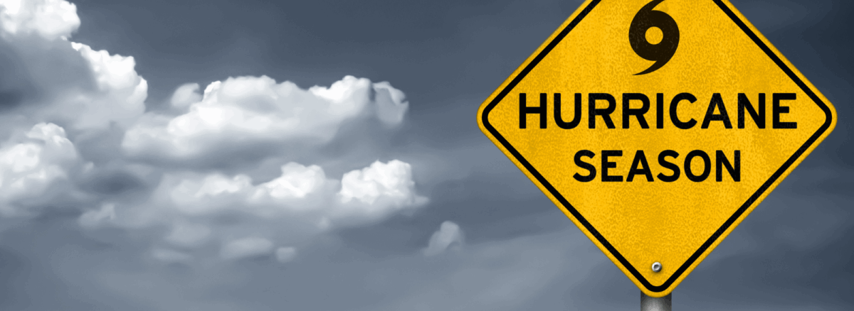 Hurricane season warning road sign against cloudy Texas sky, symbolizing storm readiness