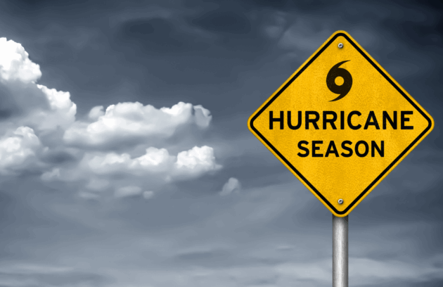 Hurricane season warning road sign against cloudy Texas sky, symbolizing storm readiness